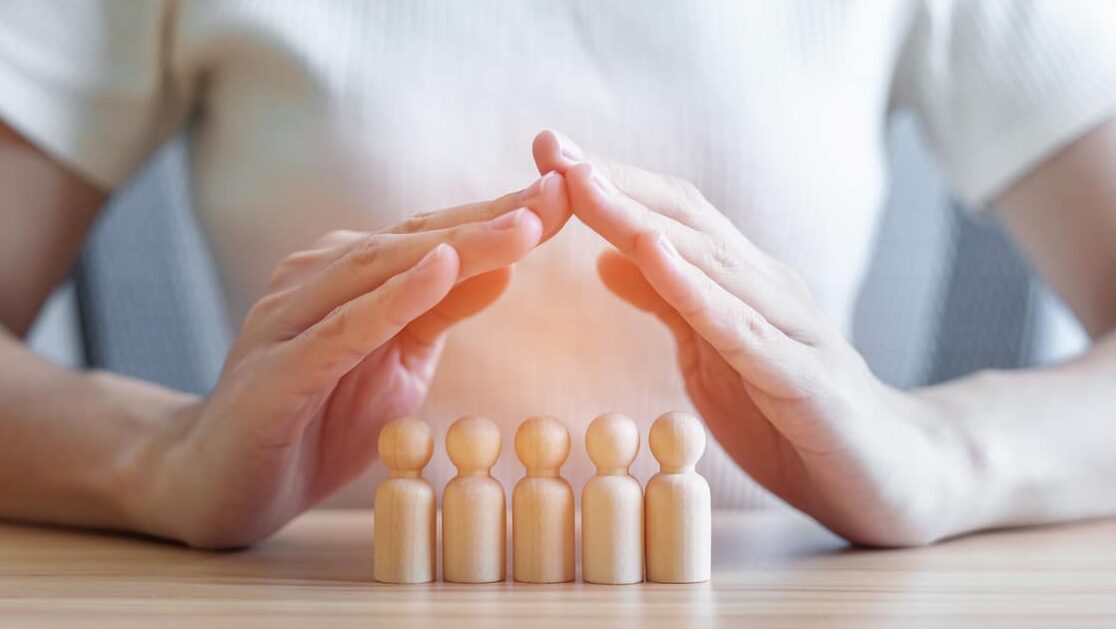 hand cover wood men from crowd of employees. people, business, human resource management, life insurance, teamwork and leadership concepts