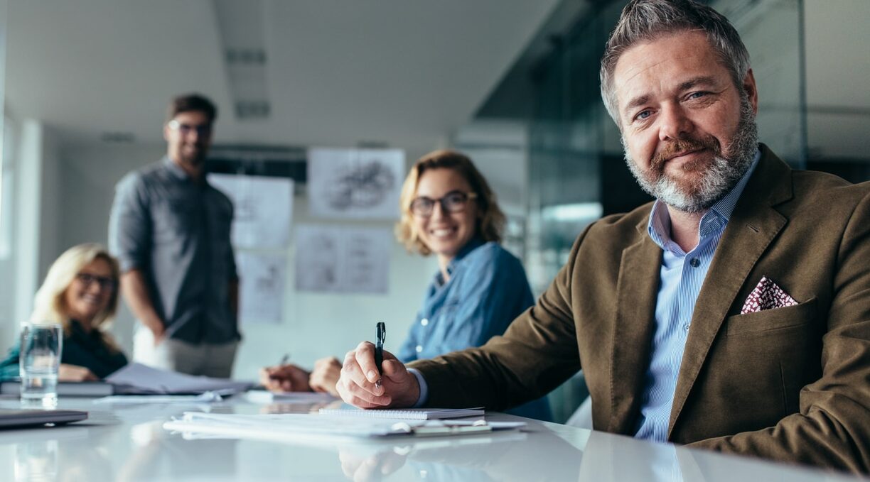 businesspeople looking at camera with smile