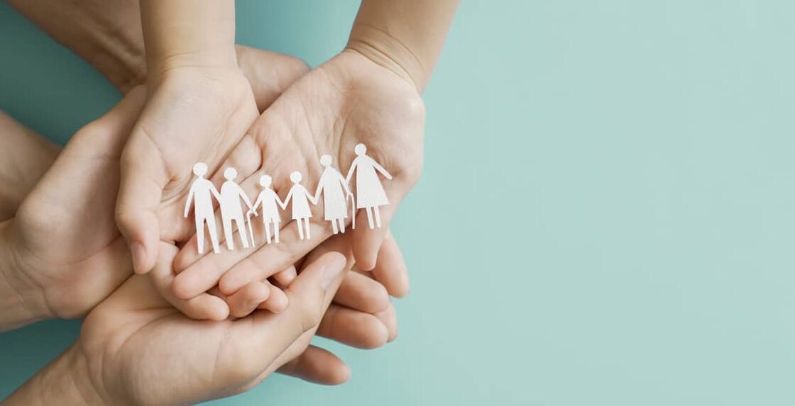 hands holding multi generation family paper, family wellness, health insurance concept
