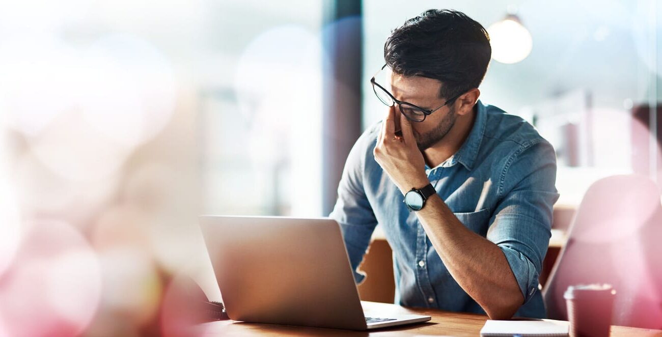 businessman, laptop and headache with copy space in office with bokeh, overlay or mock up. man, tired and burnout with stress, anxiety or mental health by computer with problem, glitch and frustrated