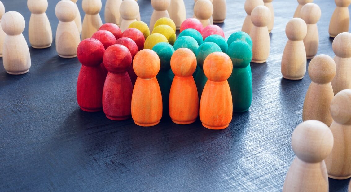 inclusion concept. group of color figures and wooden ones.