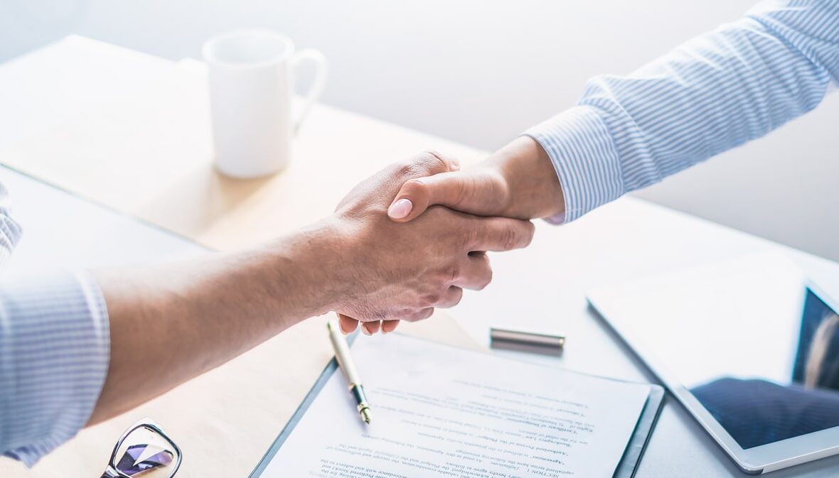 business people shaking hands, finishing up meeting.