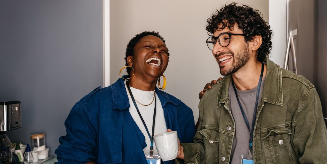 candid moment: employees at work sharing a joyful coffee break in the office, fostering friendship and laughter