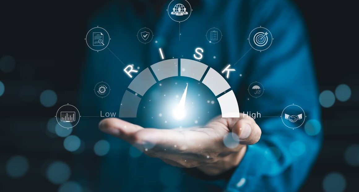 risk management and assessment concept. a person holding digital risk gauge in their hand, with icons represents various aspects of risk management and assessment, indicating different levels of risk.